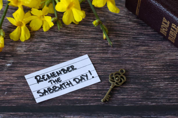 istock Remember the Sabbath Day, handwritten note with holy bible, ancient key, and flowers on wood 2080455925