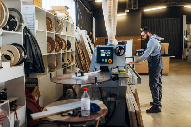 istock A carpenter works in a workshop, cuts wood, makes furniture 2080455938
