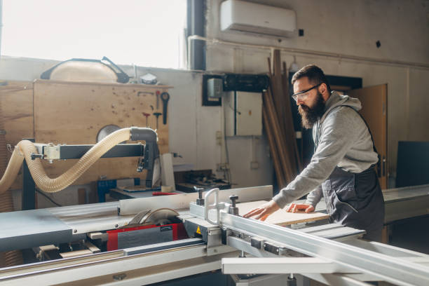 istock Bearded worker uses an industrial circular saw 2080459670