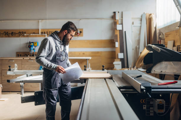 istock The craftsman prepares for cutting chipboard in the workshop using an industrial circular saw 2080460202