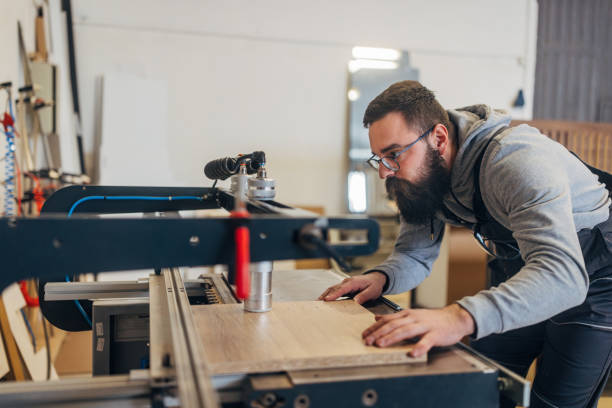 istock Focused worker uses a dowel drill machine For Drill, while making furniture in the workshop 2080463508