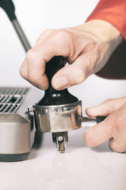 Pressing ground coffee in handle for extracting in espresso machine