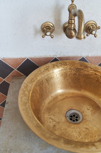 Gold sink and faucet in vintage style. High quality photo