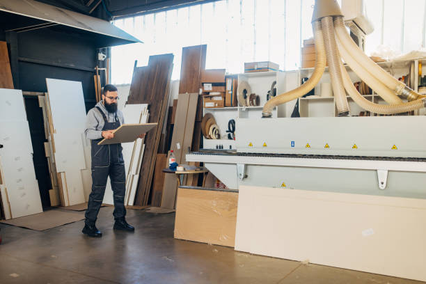 istock A worker in uniform makes furniture from wood 2080496581