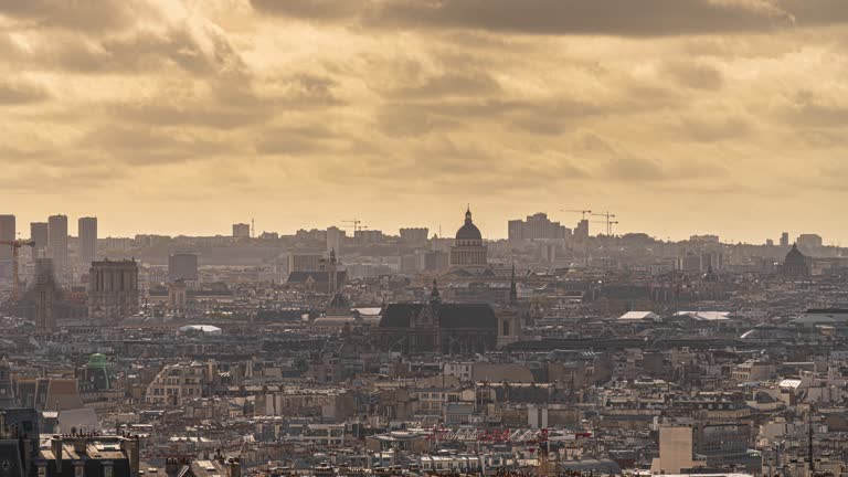 4K Footage Time lapse Top view from Montmartre viewpoint which see Paris City with Les Halles, Panthéon and Sainte-Chapelle and dramatic cloud sky in Paris, France