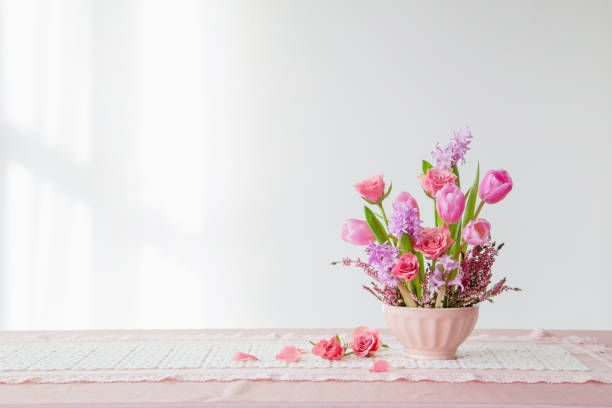 istock pink flowers in vase on background white wall 2080536726