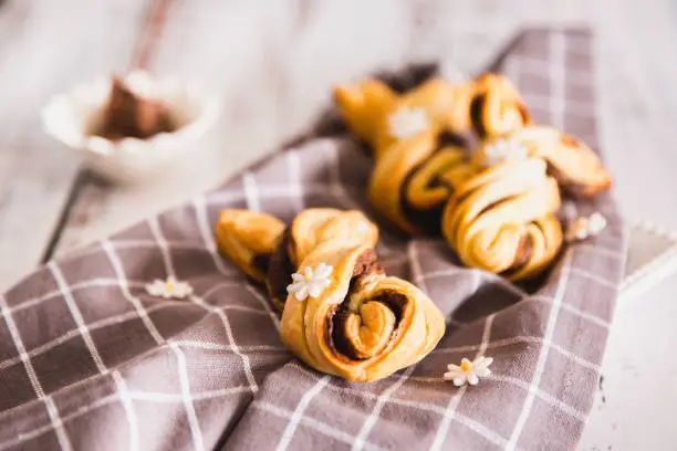 Delicious Palmiers with chocolate on wooden background. Easter concept, bunny