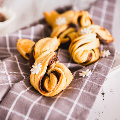 Delicious Palmiers with chocolate on wooden background. Easter concept, bunny