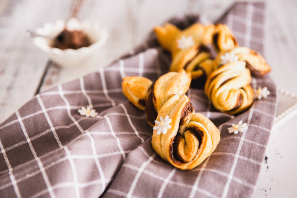 Delicious Palmiers with chocolate on wooden background. Easter concept, bunny