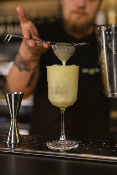 istock Strained cocktail mixture in glass complemented with ice 2080565725