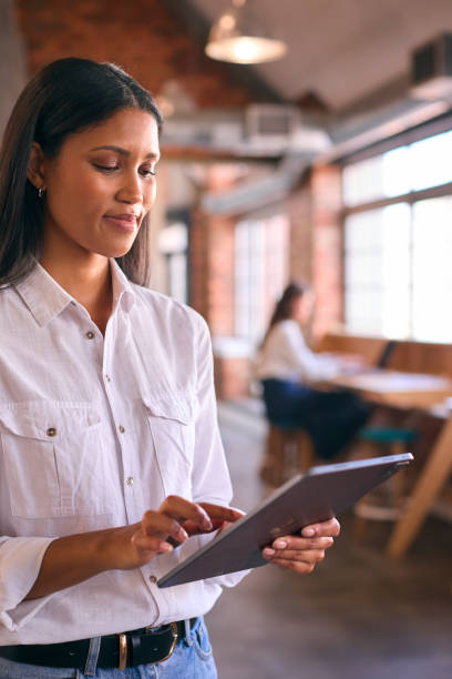 istock Young Businesswoman Using Digital Tablet Working In Modern Open Plan Office 2080587070