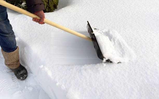 istock A man cleans the path from snow with a shovel. Snow removal 2080632253