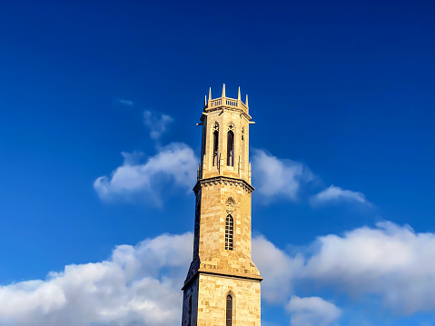 Low angle view of the tower of Saint Augustine church against cloudy sky in the city of Valencia, Spain