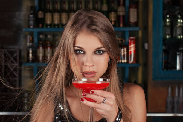 Woman with cocktail in a bar 스톡 사진