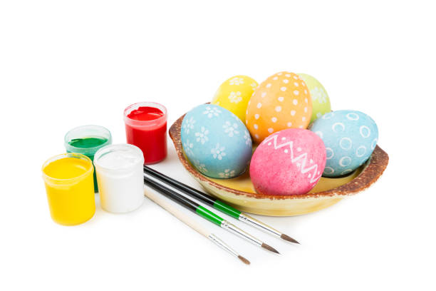 Easter egg painting at the kitchen table.Happy Easter celebration concept.Colorful Easter eggs with different patterns.Paints,decorations for coloring eggs for holiday.Creative background.Copy space