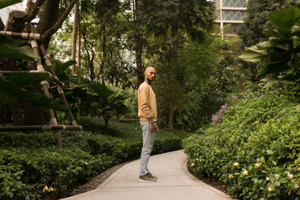 istock Serious man standing on a path in the park. 2080650998