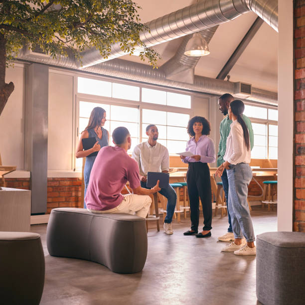 istock Multi-Cultural Business Team Having Informal Meeting Standing In Modern Open Plan Office Together 2080663644