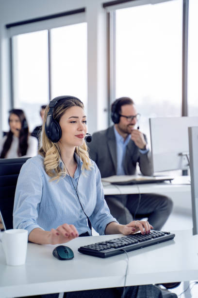 istock Attentive woman technical support agent listening to client with colleagues in customer service office, 2080668341