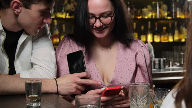 Young lady demonstrates ridiculous pictures to guy