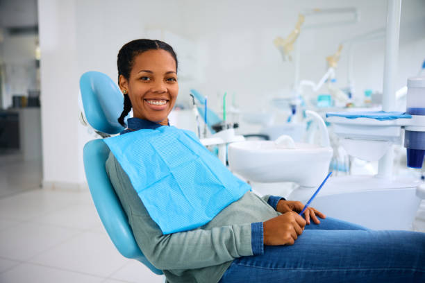 istock Happy black woman at dentist's office looking at camera. 2080697741