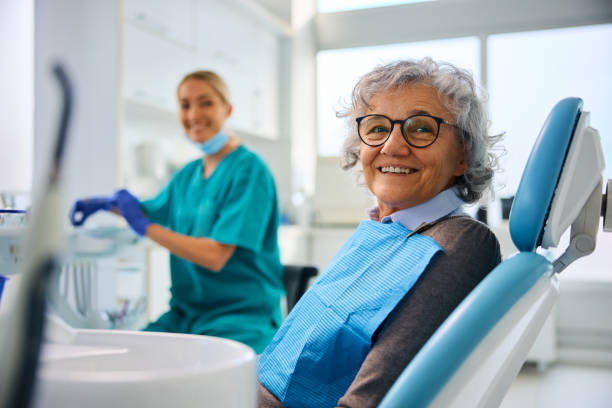 istock Happy senior woman at dentist's office looking at camera. 2080701259