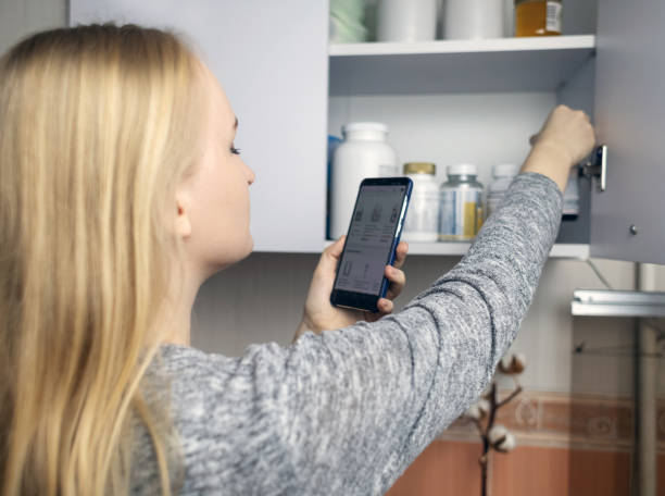 istock Girl studies dietary supplements. Reading the instructions on a bottle of vitamin complex. Nutritional supplement for hair loss and  weakened immunity. Self-prescription of drugs and harm to health 2080702536