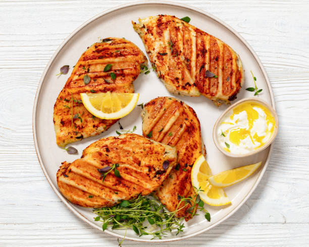 juicy grilled chicken cutlets on plate, top view