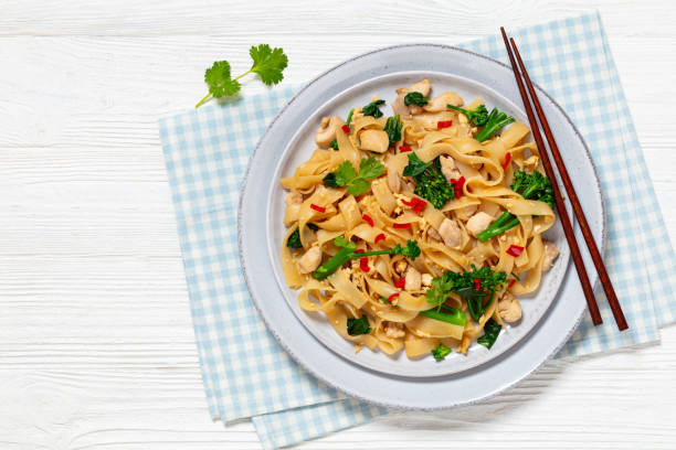 istock rice noodles with chicken, eggs, chinese broccoli 2080709909