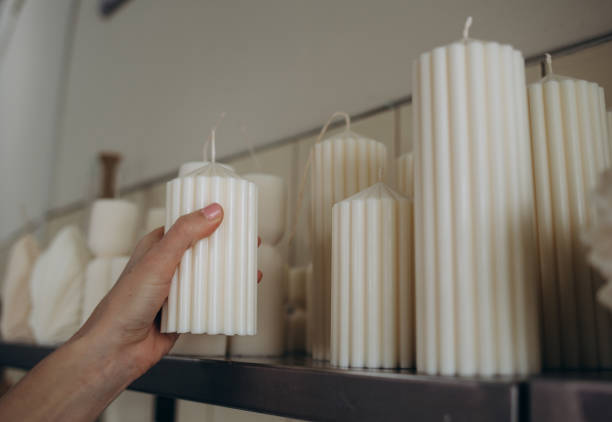 istock DIY wax candle making process. Woman making decorative wax candle and decorates with dried flowers, close-up of hands 2080714759