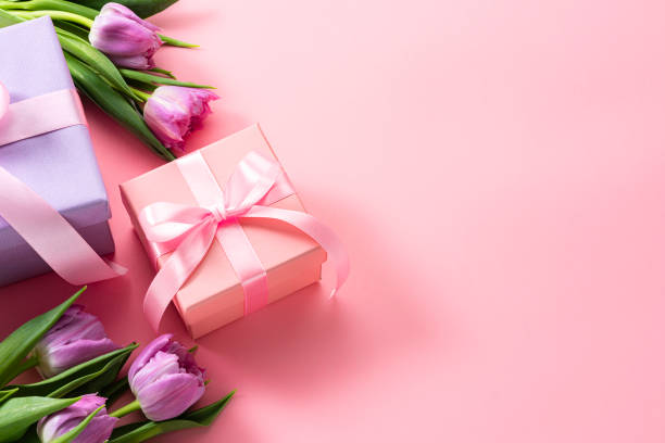 istock Mother's Day concept. Two gift boxes and tulips on pink background. Copy space 2080720704