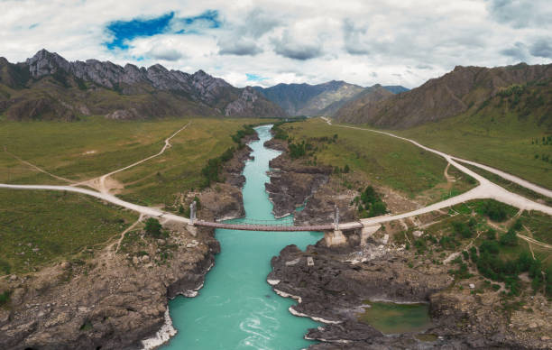 The Katun river rapids in summer day at the Oroctoy bridge in Altai Republic, Russia, Altai mountains, aerial panorama from drone
