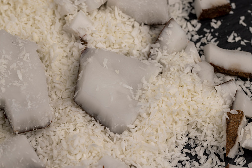 white coconut pulp and dried coconut flakes, a close-up of which is used in the preparation of desserts