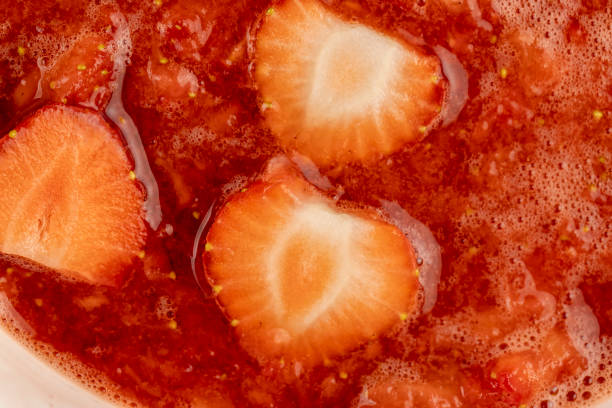 istock juice and pieces of strawberries after pressing 2080733619