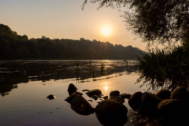 The river during the dawn in autumn , the waves on the river during the sunrise of the sun in the autumn season