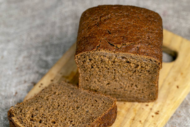 istock dark square loaf of bread on the table 2080735505
