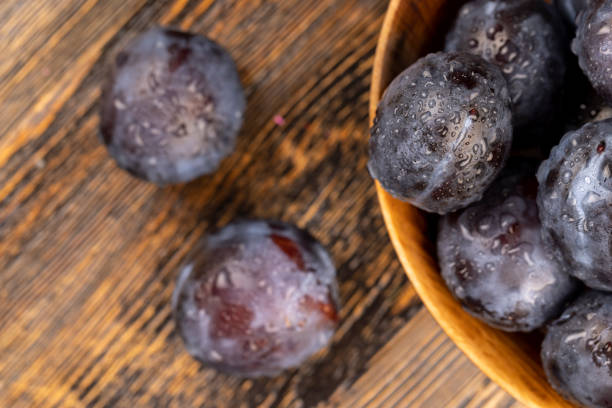 istock Wet purple plum on the table, fresh harvest 2080736062