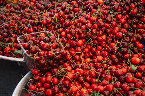 Cherries sale in the traditional farm Turkish market, a counter filled with fresh fruits
