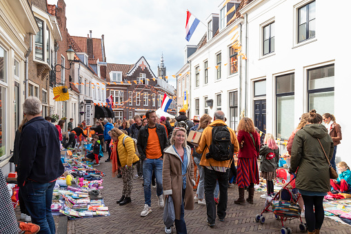 Amersfoort, Netherlands, April 27, 2022; People walk through the flea market on King's Day in the city of Amersfoort, where children and adults offer old things for sale on the street.