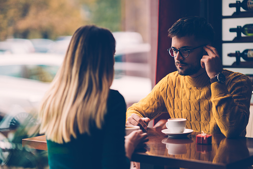 Young couple having a serious discussion over coffee at the restaurant