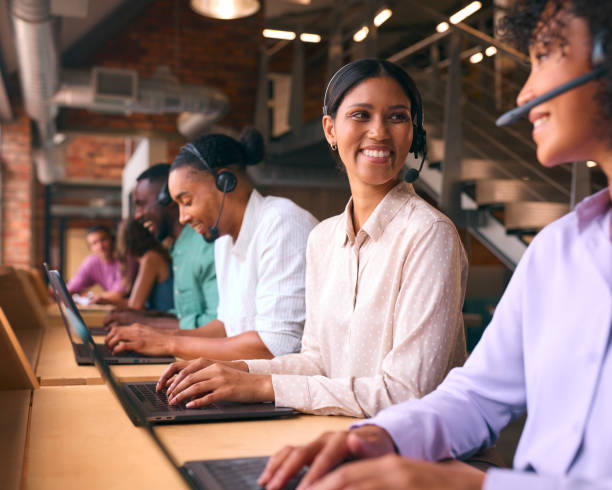 istock Multi-Cultural Customer Support Or Telesales Team In Modern Open Plan Office Wearing Headsets 2080768811