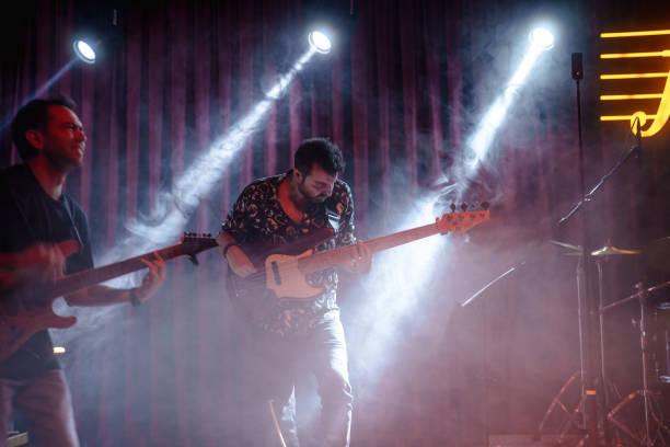 istock Music Band Performing on, stage light and smoke effects. 2080771924