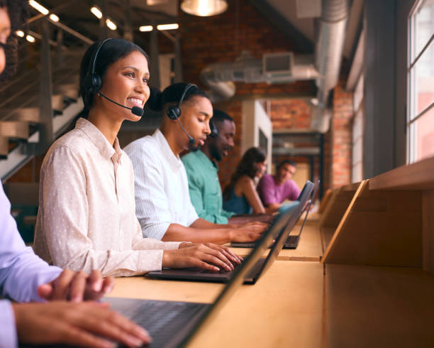 istock Multi-Cultural Customer Support Or Telesales Team In Modern Open Plan Office Wearing Headsets 2080775314
