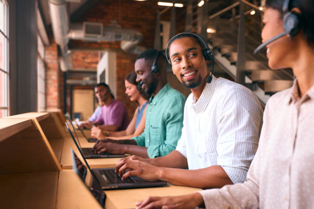 istock Multi-Cultural Customer Support Or Telesales Team In Modern Open Plan Office Wearing Headsets 2080777681