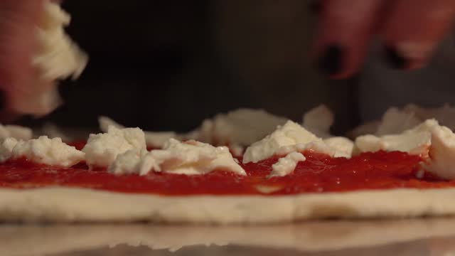 Italy: homemade pizza: seasoning with tomato and mozzarella cheese