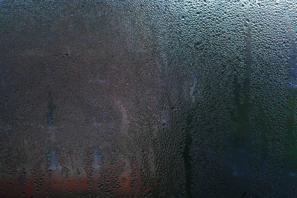 istock drops on the window glass. condensation on the glass 2080805492