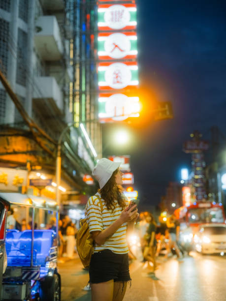istock Woman using smartphone while exploring Chinatown in Bangkok during vacation 2080809712