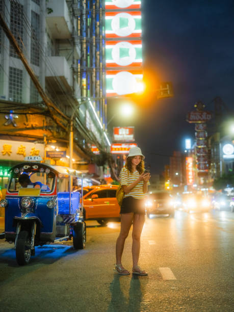 istock Woman using smartphone while exploring Chinatown in Bangkok during vacation 2080809713