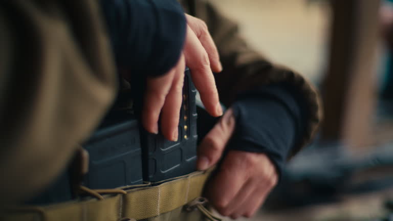 Soldier expertly loads magazine onto waist