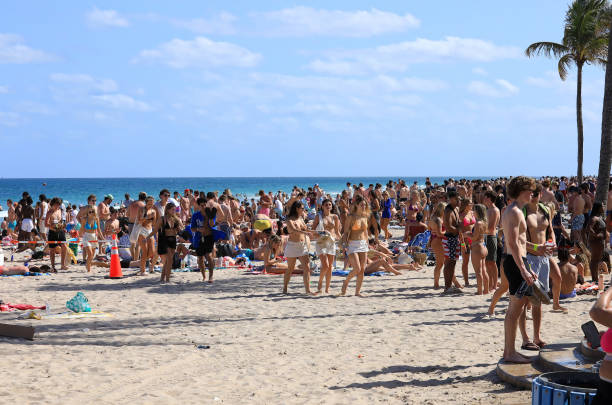 Fort Lauderdale, Florida, USA - March 11, 2024:  Large group of university students enjoying Spring Break on Fort Lauderdale Beach.