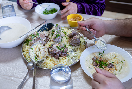 Family eating mansaf on dinner  for iftar